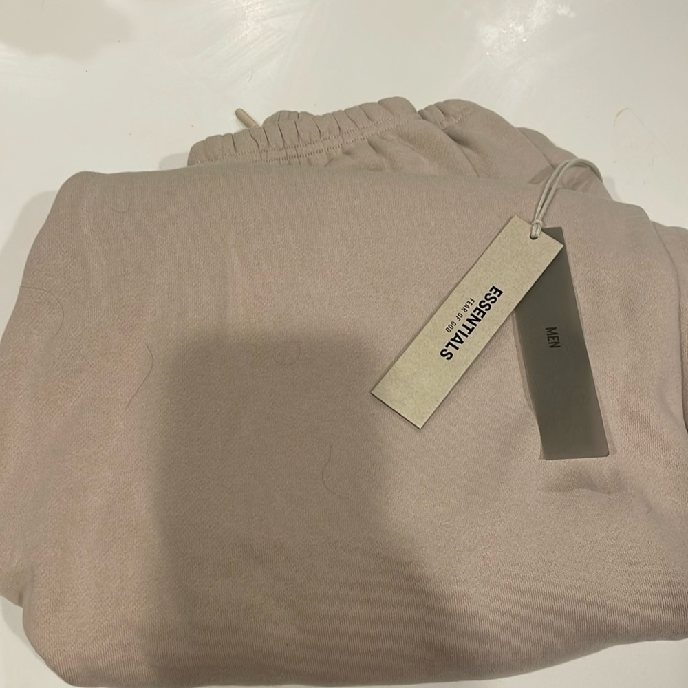 Brand new never works men’s essential sweatpants in size XL.  Color is tan.